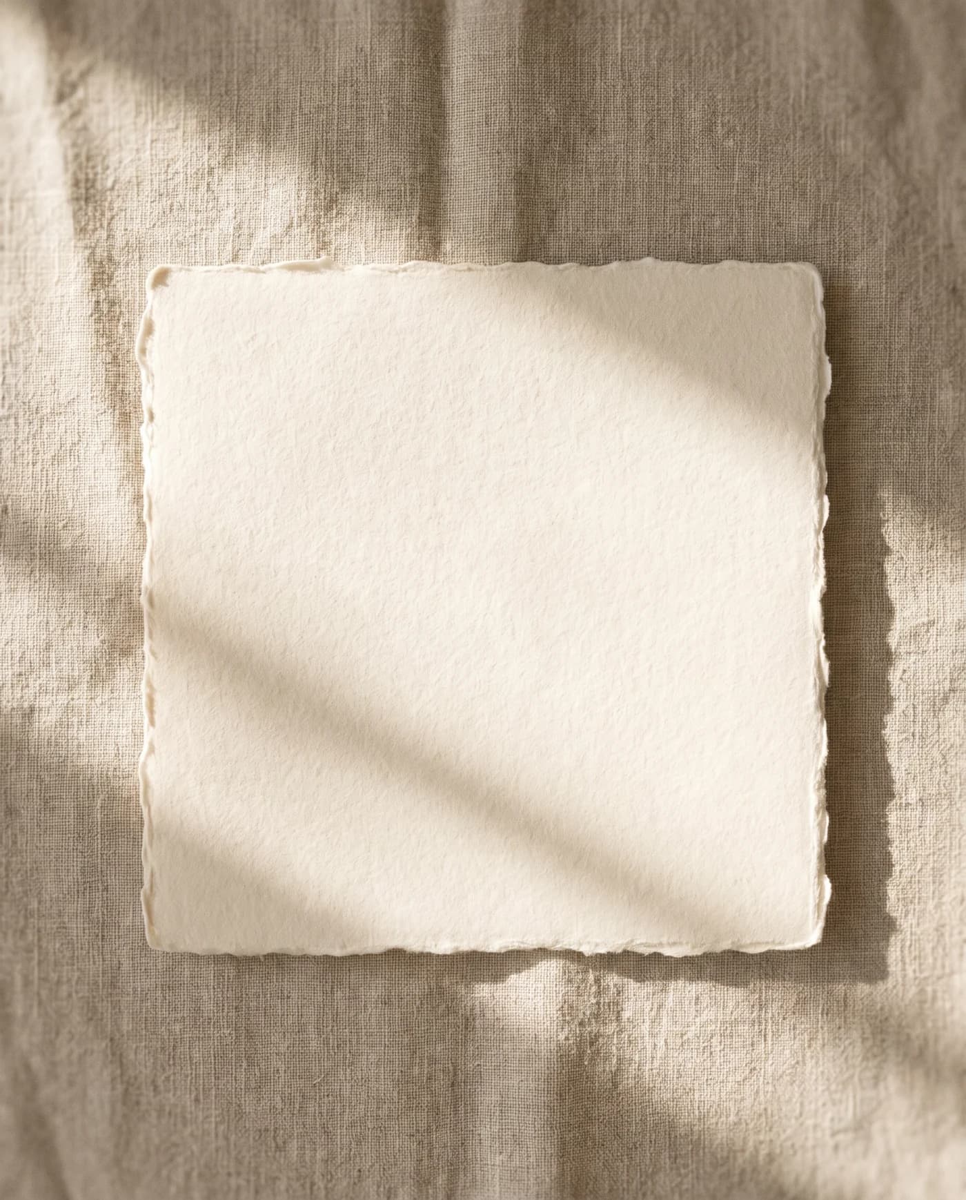 The Almighty Concept mark blind-embossed into a sheet of cream cotton rag